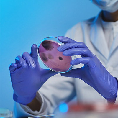 lab worker holding a petri dish